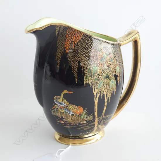 A Carlton ware 'New Stork' pattern, famille noir enameled jug